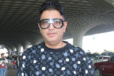 Producer Bhushan Kumar greets paps at the airport
