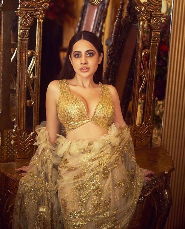 Uorfi Javed is coated in gold as she drapes an extravagant gleaming saree created by the designer duo Abu Jani and Sandeep Khosla 
