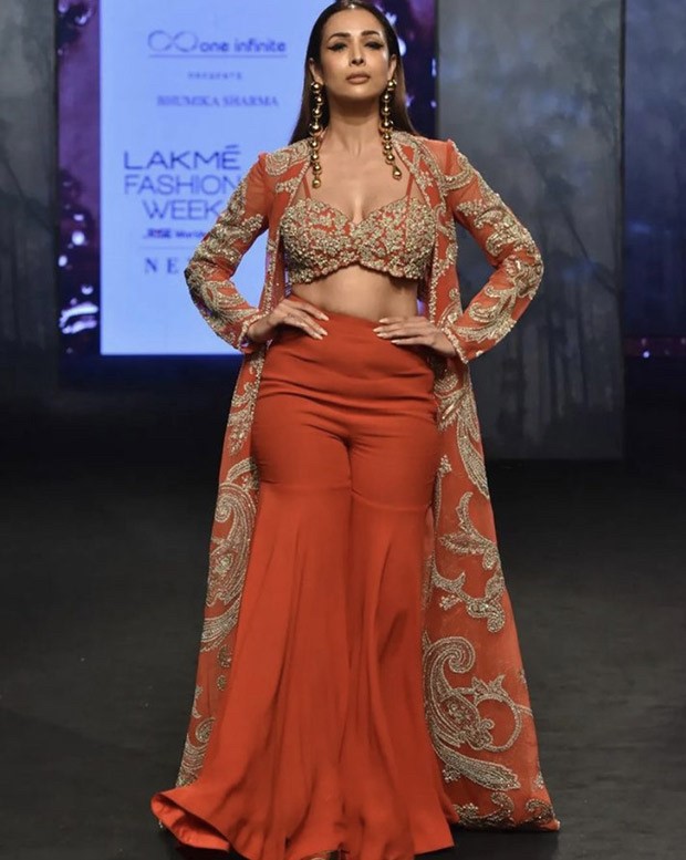 Malaika Arora steals the show in an equally classic and contemporary crimson sharara and jacket by Bhumika Sharma during Lakme Fashion Week