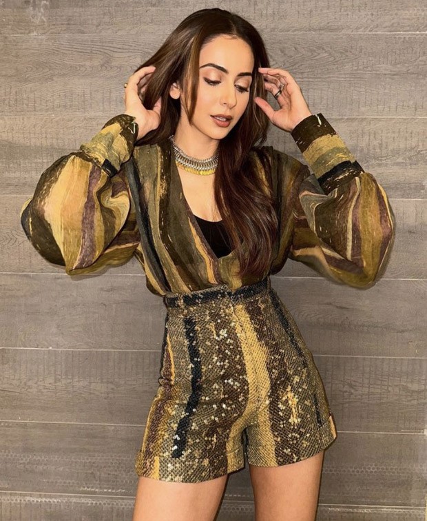 The shimmering set worn by Rakul Preet Singh, which consists of a top and shorts covered in sequins, is our pick for a party look