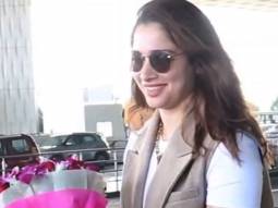 Tamannaah Bhatia receives flowers and gifts from a fan at the airport