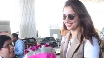 Tamannaah Bhatia receives flowers and gifts from a fan at the airport