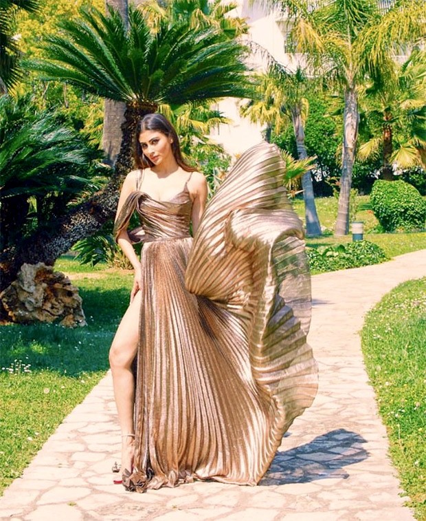 Mouni Roy gives us a hefty dose of glam in a stunning metallic dress that features multiple pleats and a daring side slit