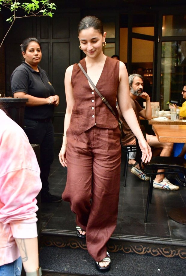 Alia Bhatt perfects the relaxed elegant look with casual brown pants and a waistcoat, together with a Gucci bag costing Rs. 1.35 lakh