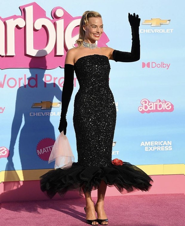 Barbie: Margot Robbie channels 1960′s Solo in the Spotlight doll in Schiaparelli for the LA premiere; Ryan Gosling stuns in crisp peach suit with custom Barbie necklace