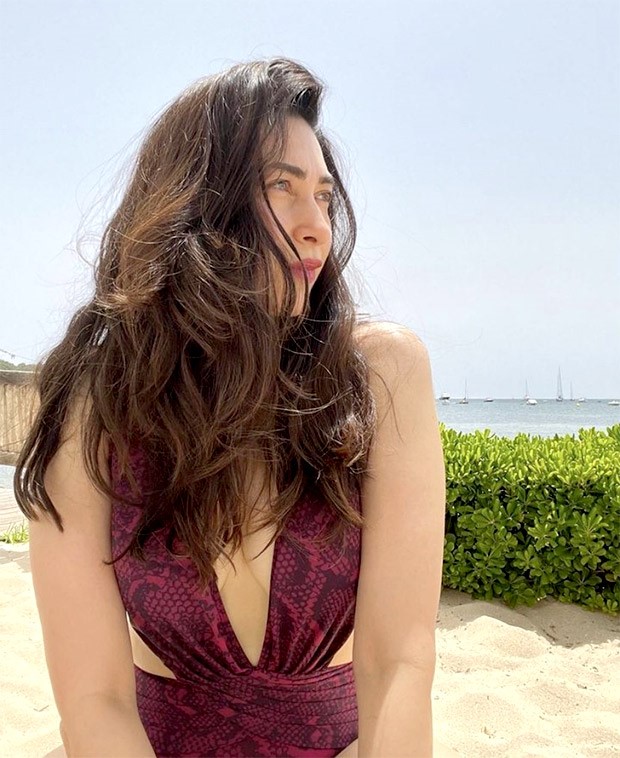 Karisma Kapoor in a maroon snakeskin patterned monokini is the most stylish beach babe