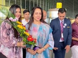 Fan gifts a bouquet of flowers to Hema Malini at the airport