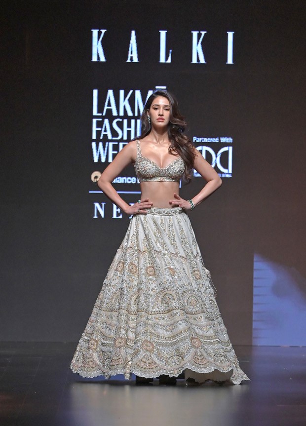 Disha Patani adds a touch of festive elegance to the Lakme Fashion Week 2023 runway, dazzling in an ivory lehenga by Kalki Fashion