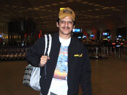 Vijay Varma poses for a picture with fans as he gets clicked at the airport