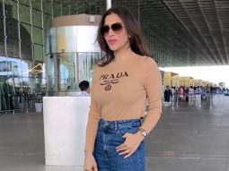 Sophie Choudry is all smiles as she greets paps at the airport