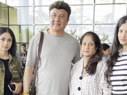 Anu Malik poses with family as he gets clicked at the airport