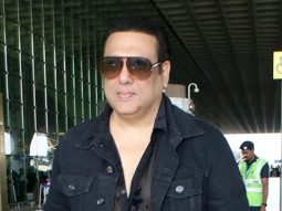 Govinda looks dapper dressed in all black as he smiles for paps at the airport