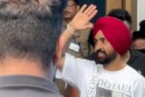 Diljit paji waves to the paps at the airport