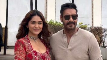 Mrunal Thakur with a glamour red fit pose with co star Ajay Devgn
