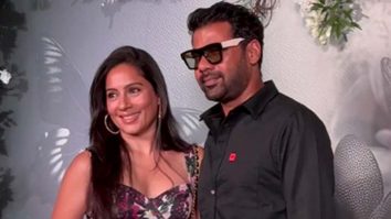 Shabir Ahluwalia in an all black outfit pose with his wife