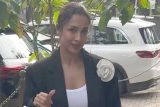 The white flower on the coat is a main character fr! Malaika Arora
