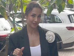 The white flower on the coat is a main character fr! Malaika Arora