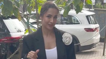 The white flower on the coat is a main character fr! Malaika Arora